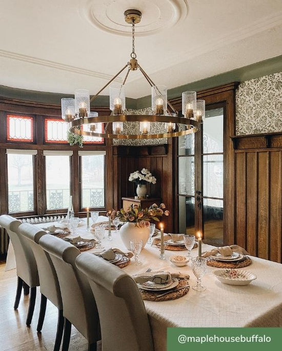 Hartland 12 light chandelier hanging over dining table in dining room.